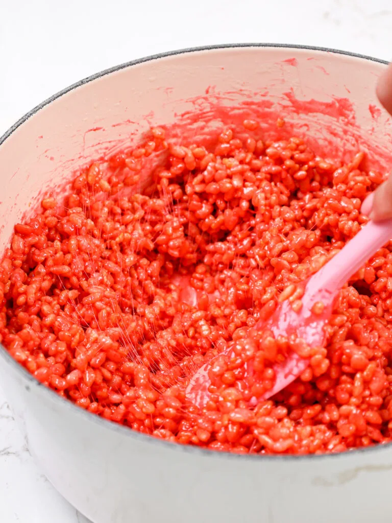 image of strawberry rice krispie treats being made in a large pot
