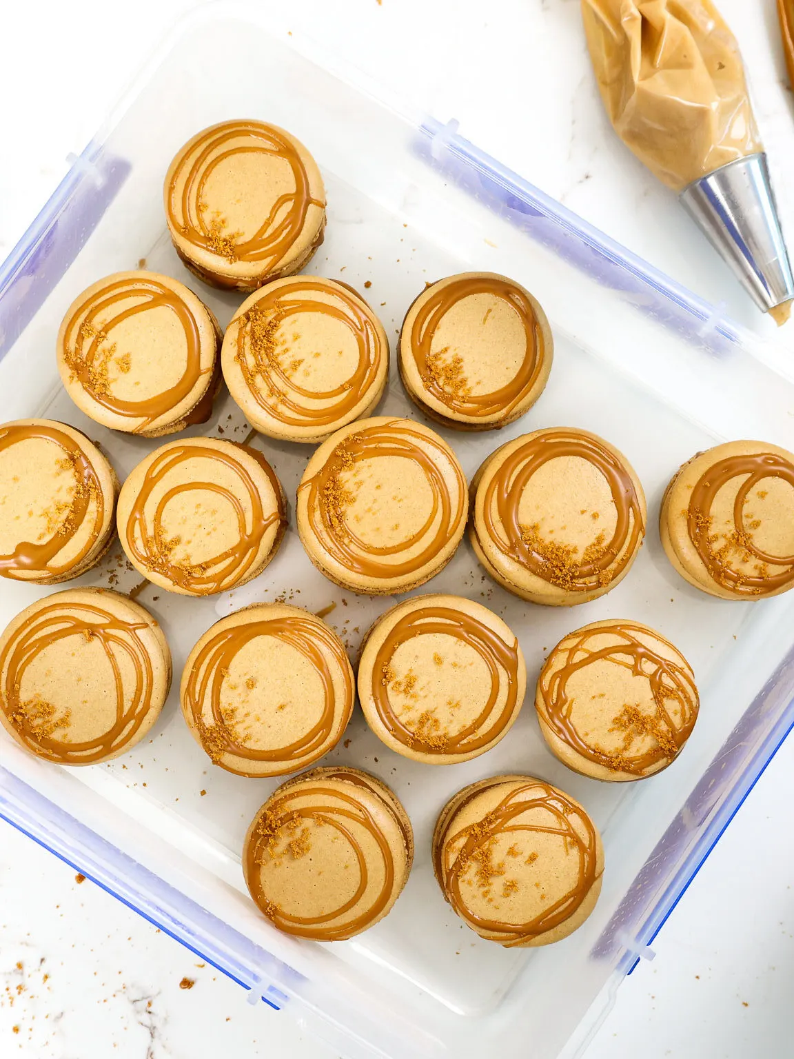 image of biscoff cookie butter macarons that have been placed in an airtight container to mature in the fridge overnight
