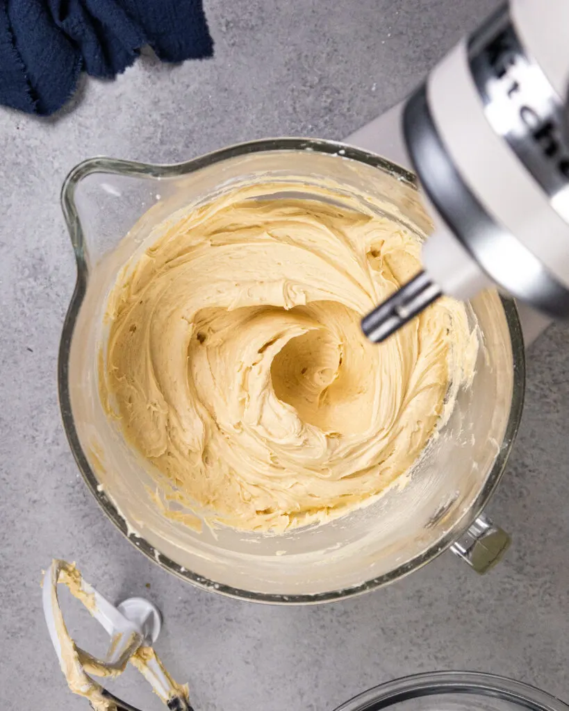 https://chelsweets.com/wp-content/uploads/2022/07/overshot-of-peanut-butter-frosting-being-mixed-in-a-kitchenaid-edited-819x1024.jpg.webp