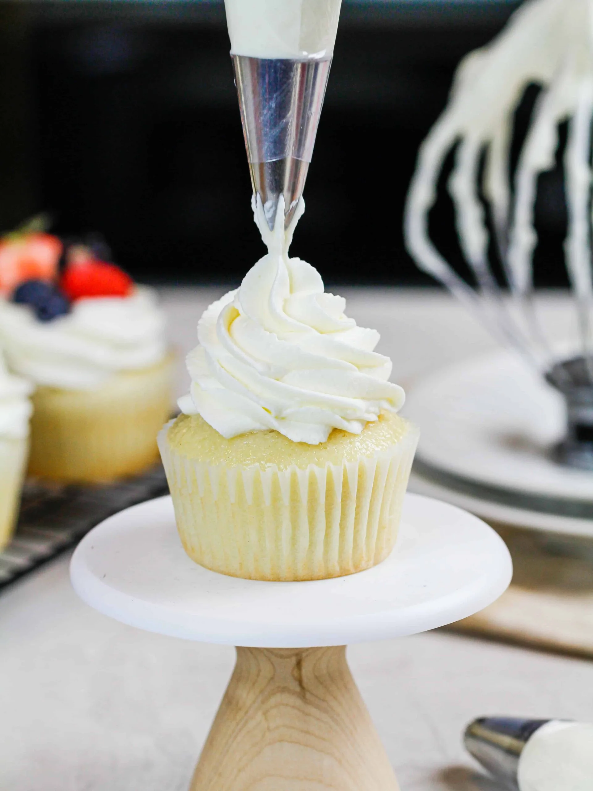 image of mascarpone cream being piped onto a cupcake