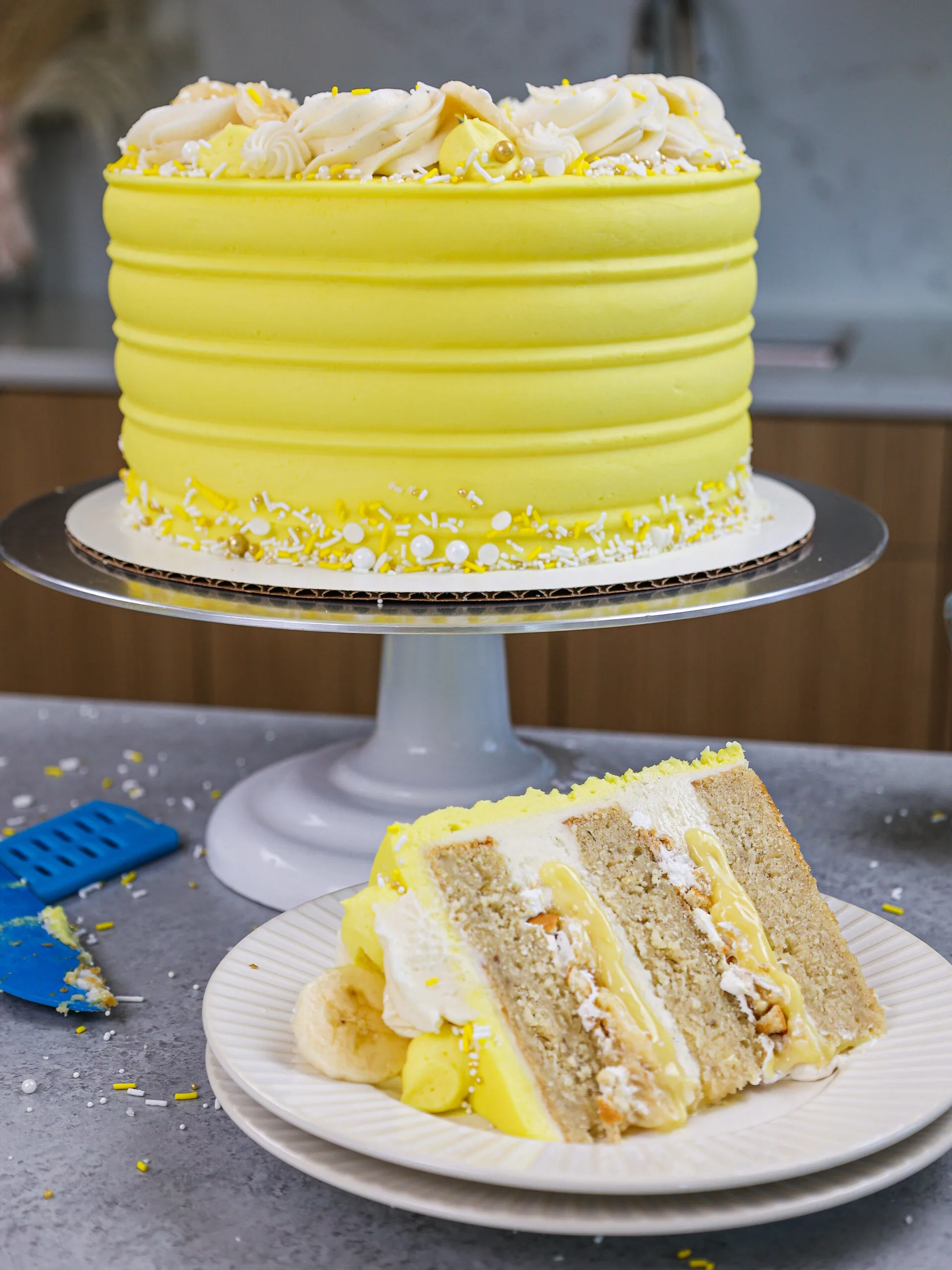 image of a banana pudding layer cake that's been cut into to show it's delicious banana pudding filling 
shared as part of a banana recipe round up