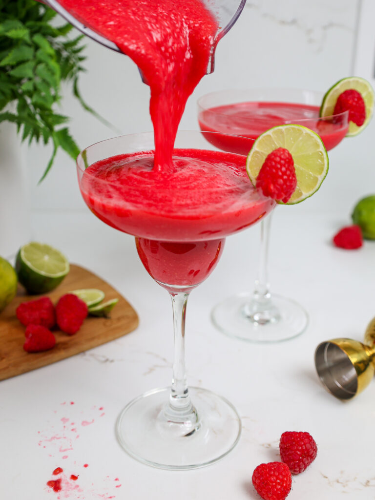 image of a frozen raspberry daiquiri that's been poured into a margarita glass