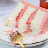 image of a slice of strawberry mousse cake that's been cut into to show how delicious it is