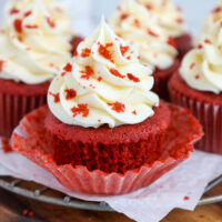 image of a moist red velvet cake that's been unwrapped and frosted with cream cheese frosting