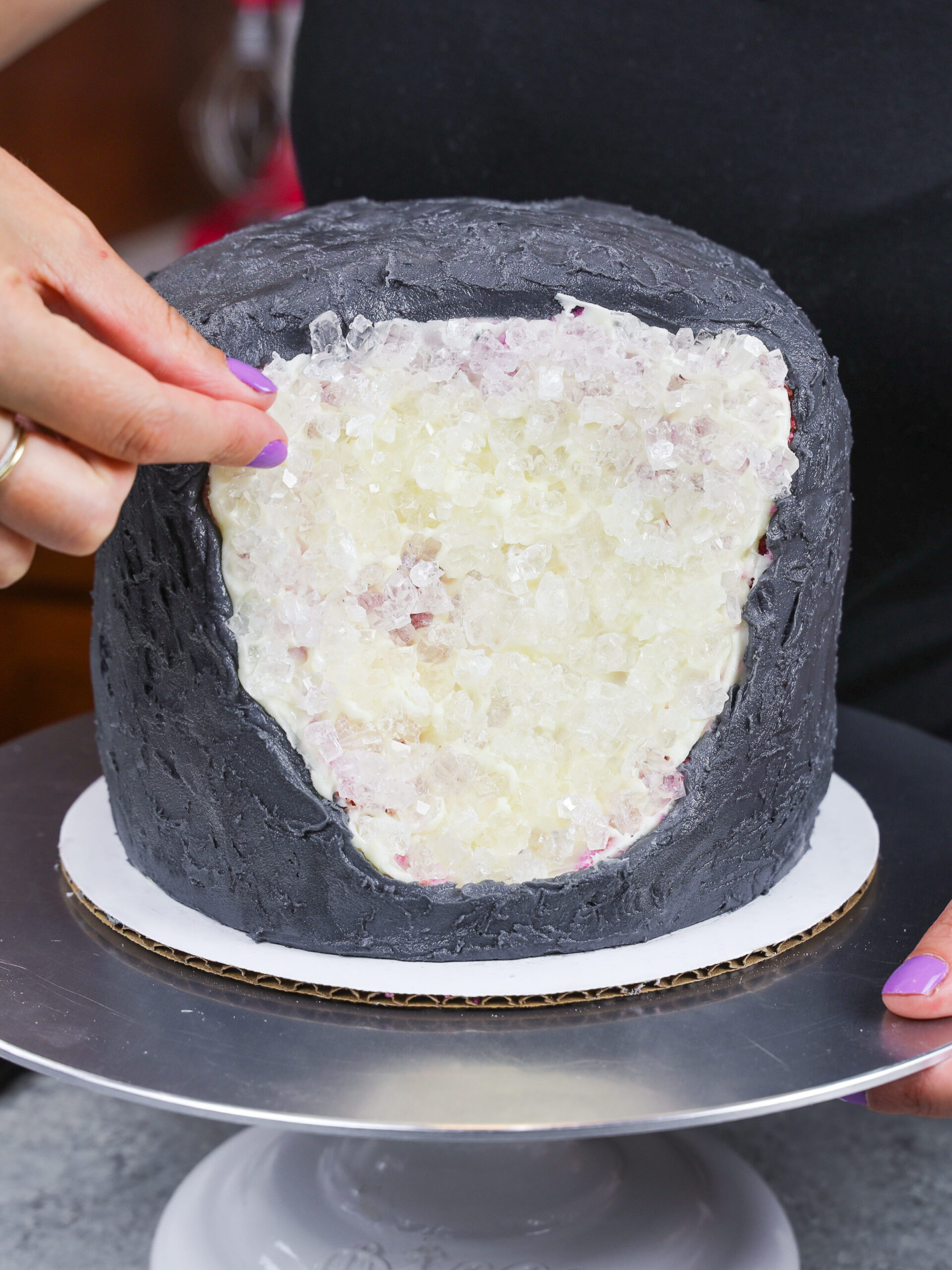 image of rock candy being pressed into a cake to make a geode cake