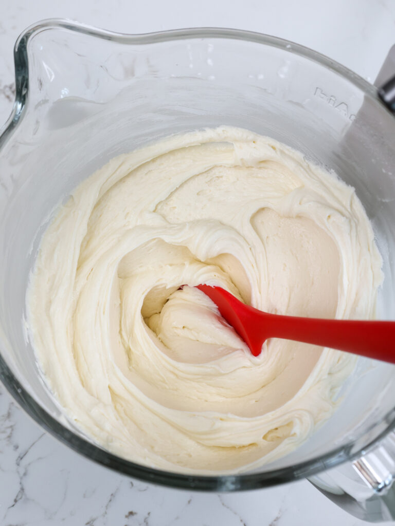 image of buttercream frosting in a glass mixing bowl