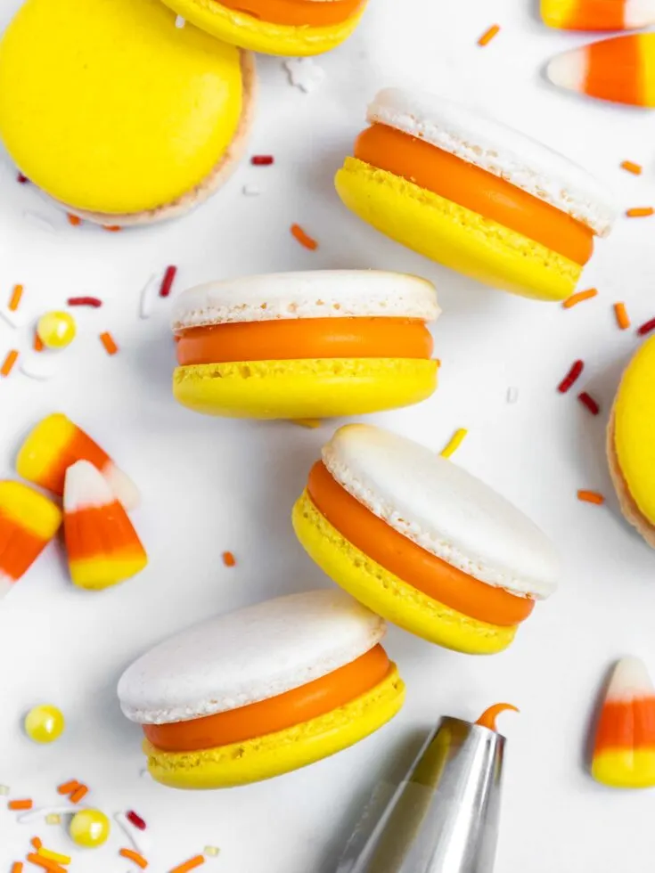 image of candy corn macarons that have been filled with candy corn ganache