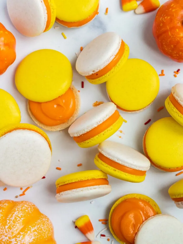 image of candy corn macarons that have been filled with candy corn ganache