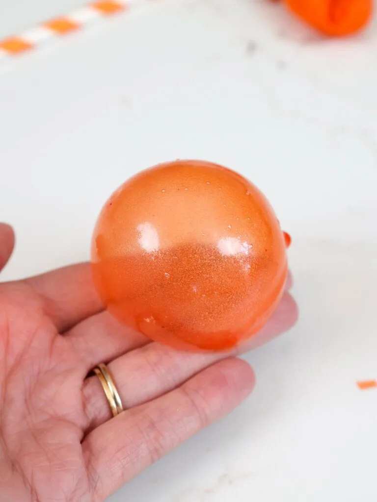 image of an orange gelatin bubble that's been made with small balloons
