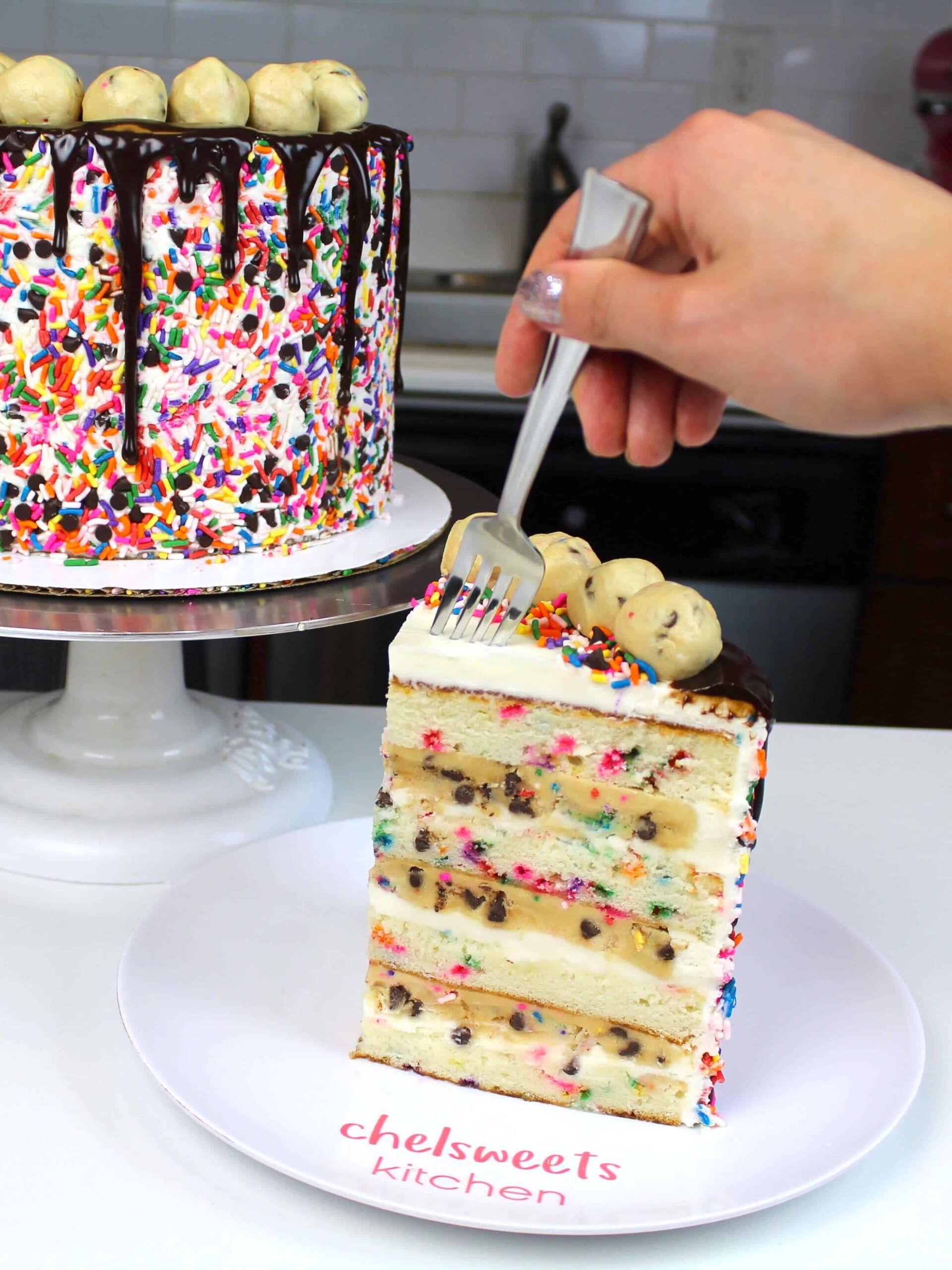 image of a slice of funfetti cookie dough cake on a plate