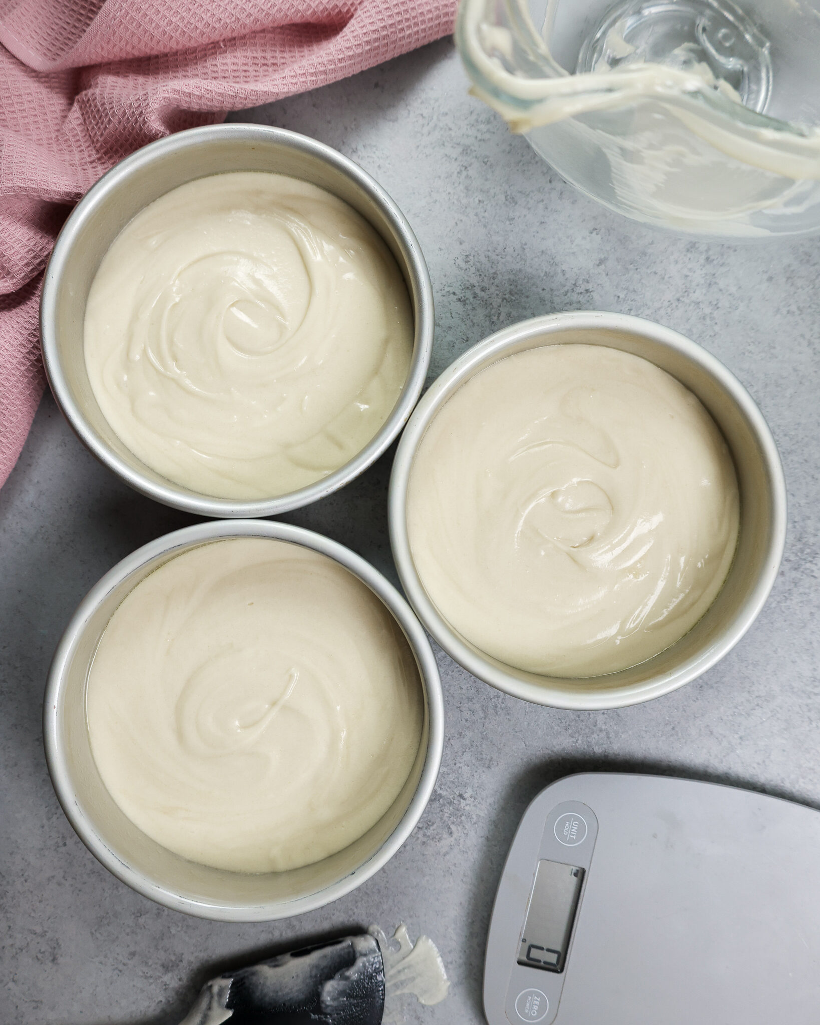 image of vanilla cake batter that's been poured into 6-inch cake pans and is ready to be baked