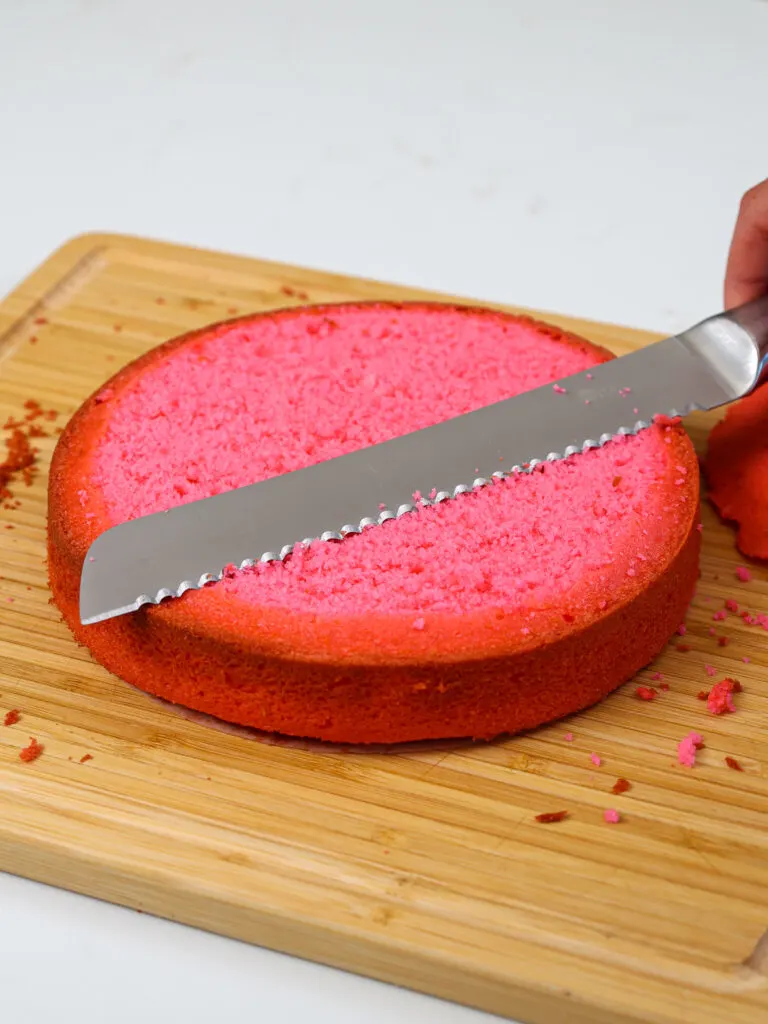 image of a hot pink cake layer that's been leveled with a serrated knife