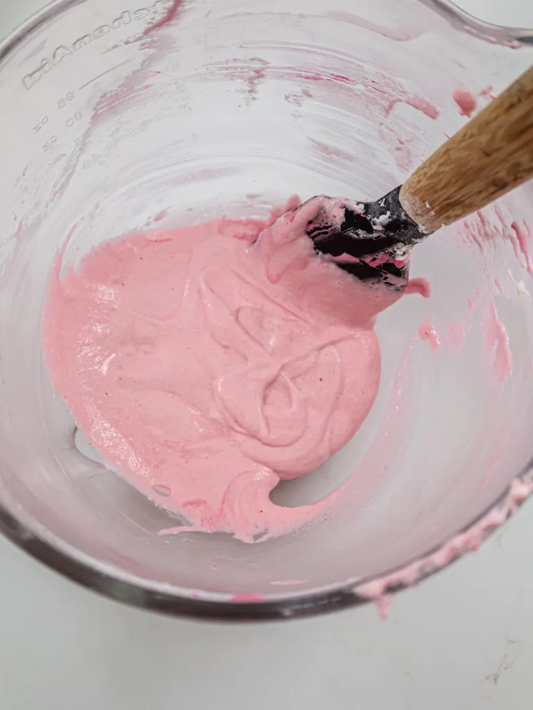 image of light pink macaron batter that's been mixed properly and passed the figure 8 test
