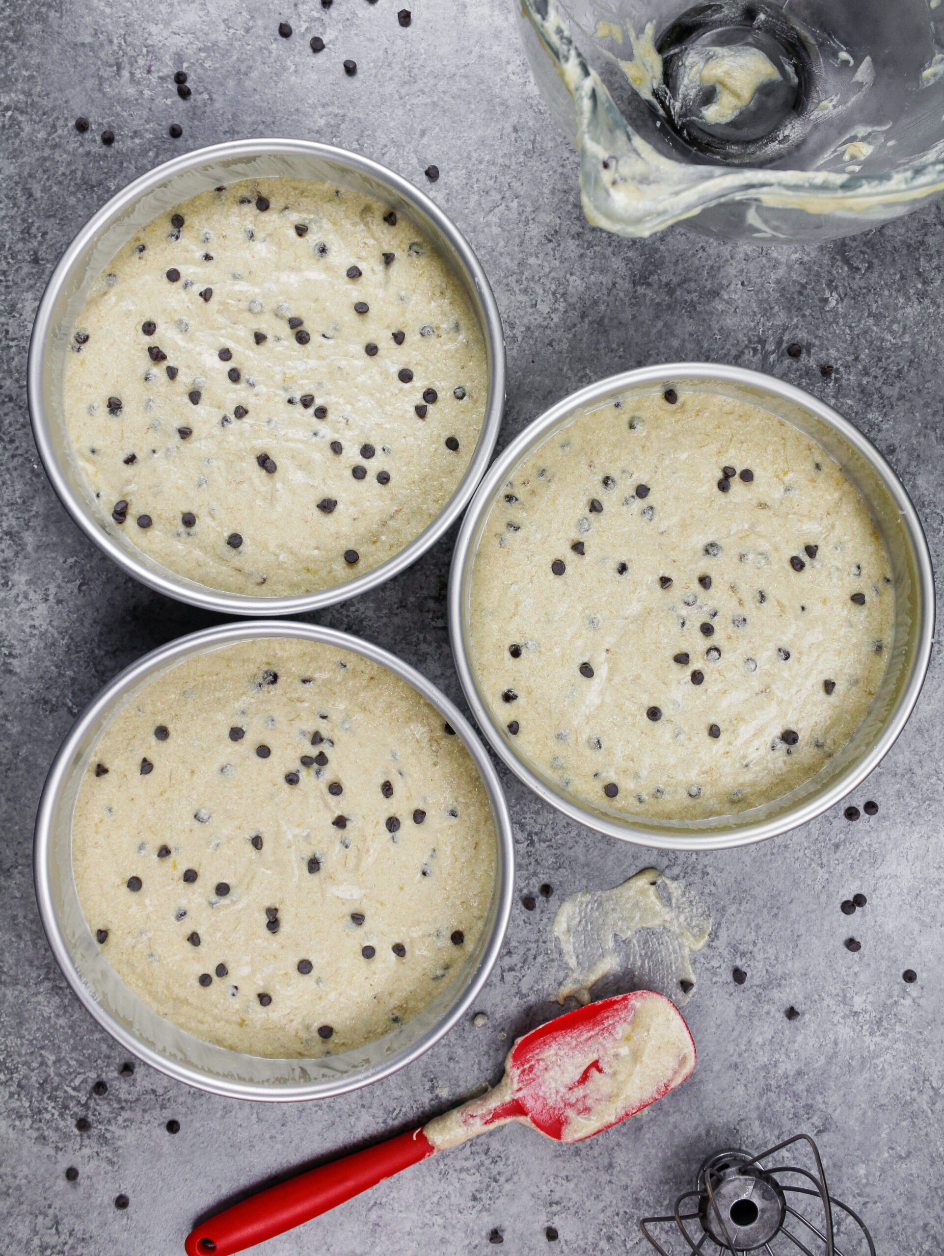 image of chocolate chip banana cake layers in an 8-inch pan ready to be baked