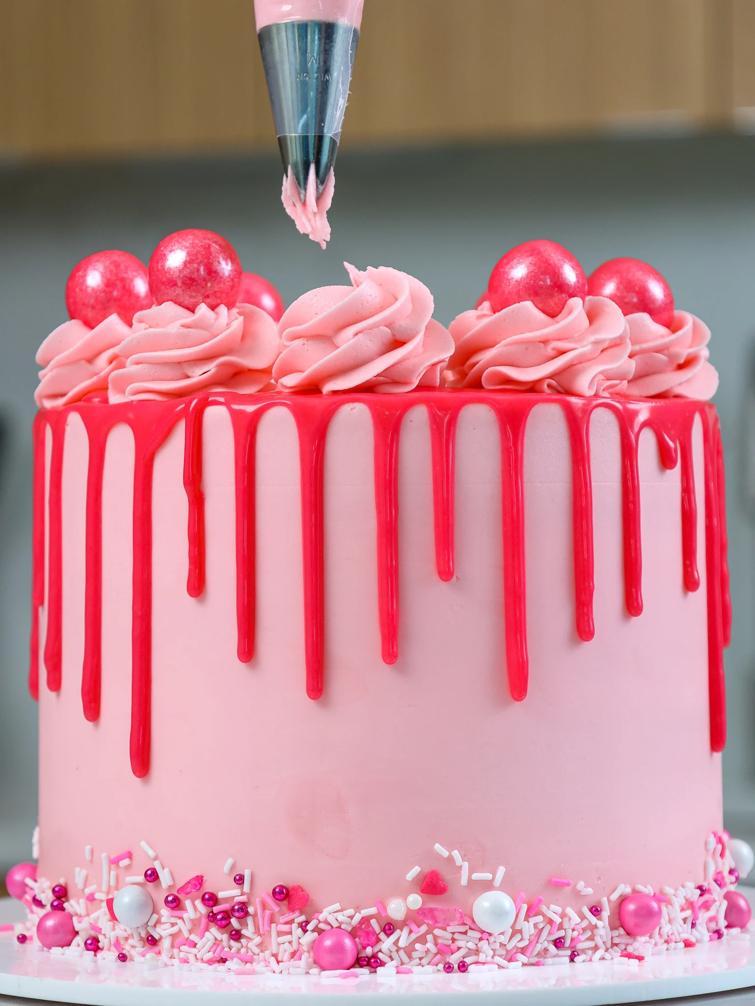 image of bubblegum frosting being piped onto a cake