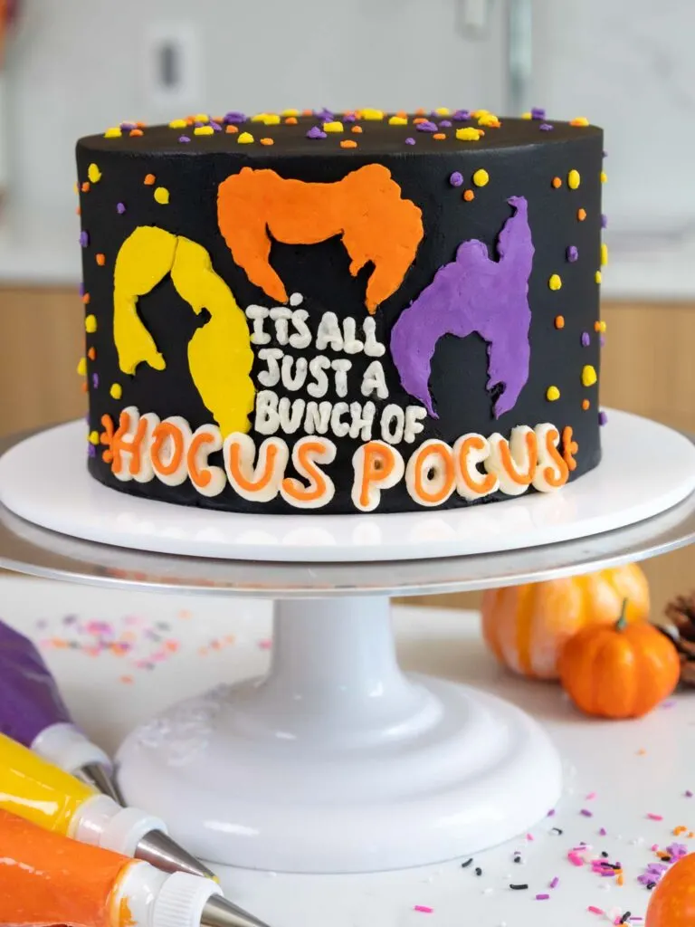 image of a buttercream hocus pocus cake made with black cocoa frosting and cake layers