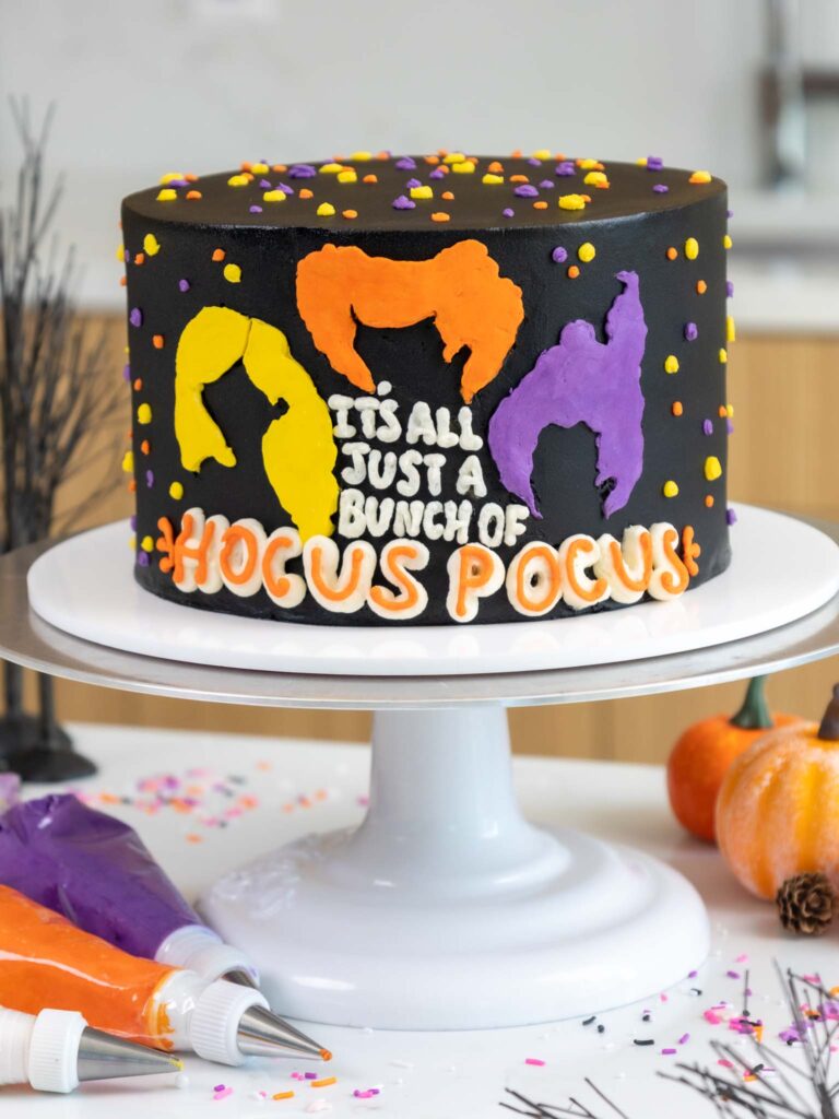 image of a buttercream hocus pocus cake made with black cocoa frosting and cake layers