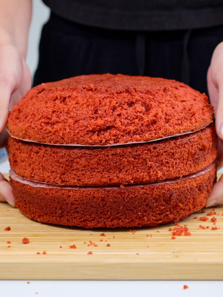 image of red velvet cake layers that have been trimmed to have a curved top to make a crab cake