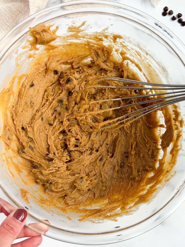 image of gluten free peanut butter cookie dough that's been mixed together in a glass bowl and is ready to be scooped and baked