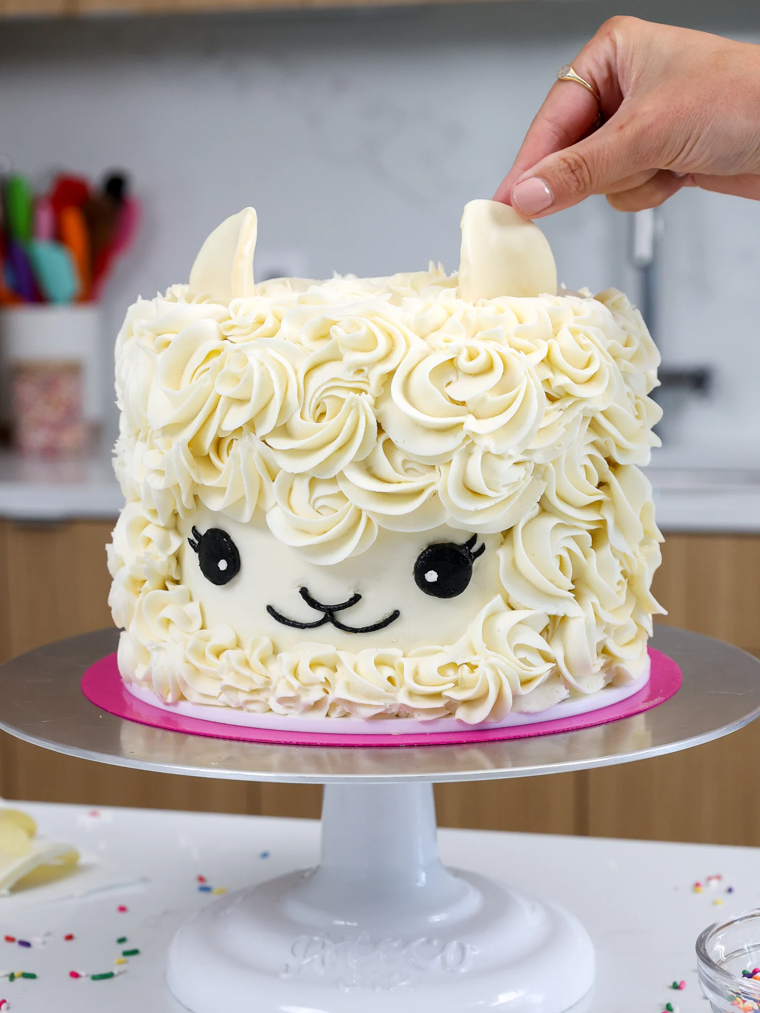 image of ears being added onto an easy llama birthday cake