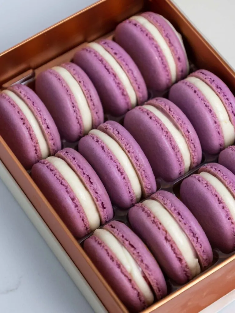 image of blackberry macarons packaged in a cute box 