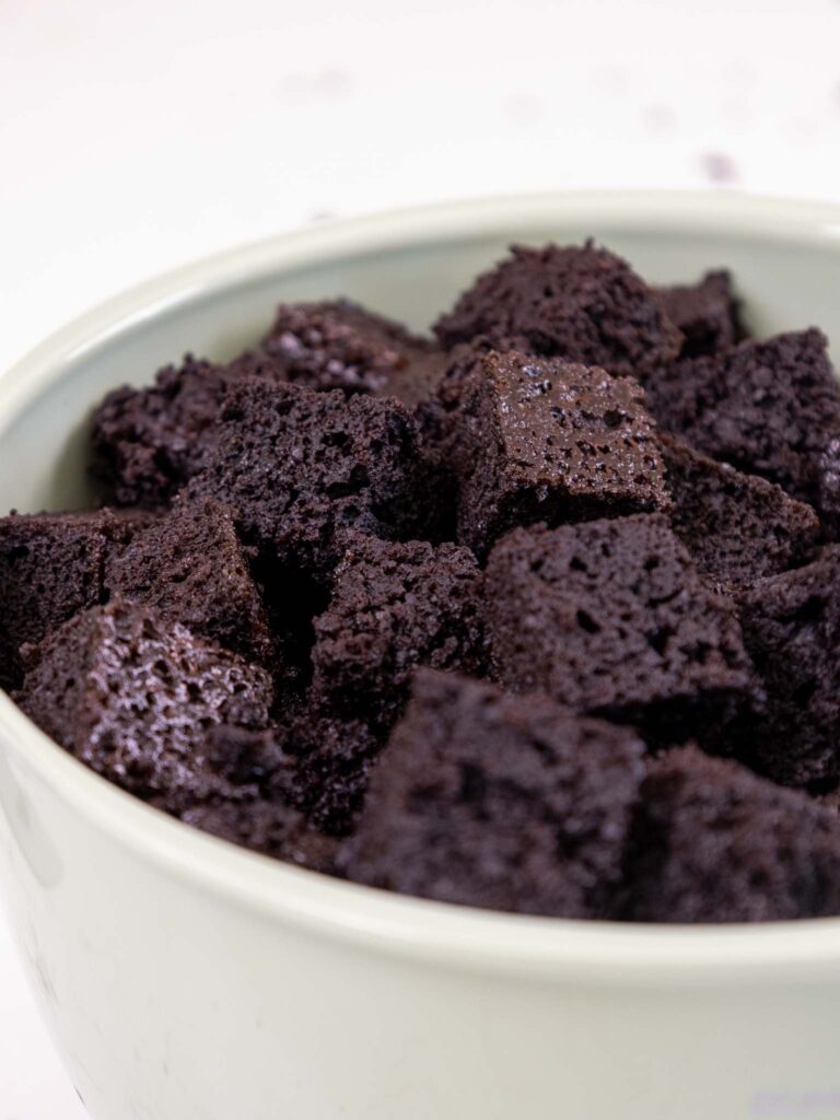 image of cubed chocolate sheet cake in a bowl