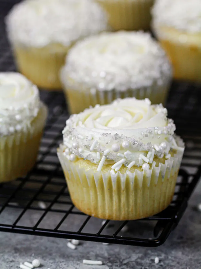 image of almond cupcakes that have been frosted with almond buttercream on a wire rack