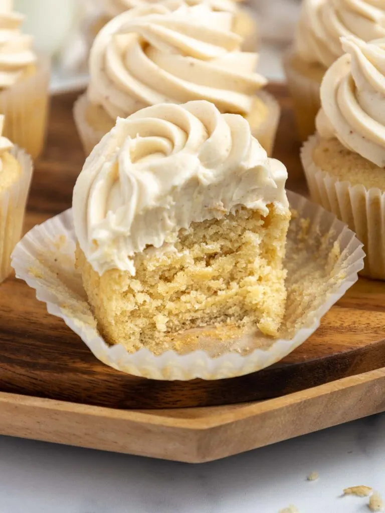 image of a brown butter cupcake that's been bitten into to show how tender and moist it is