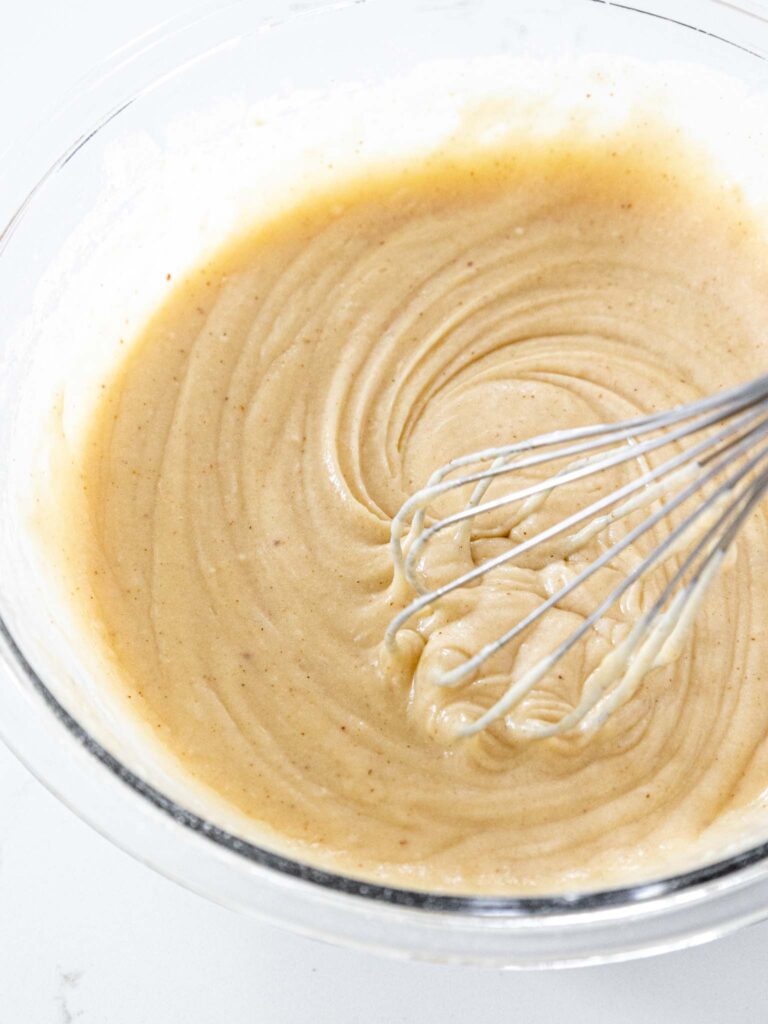 image of brown butter cupcake batter being mixed together with a whisk