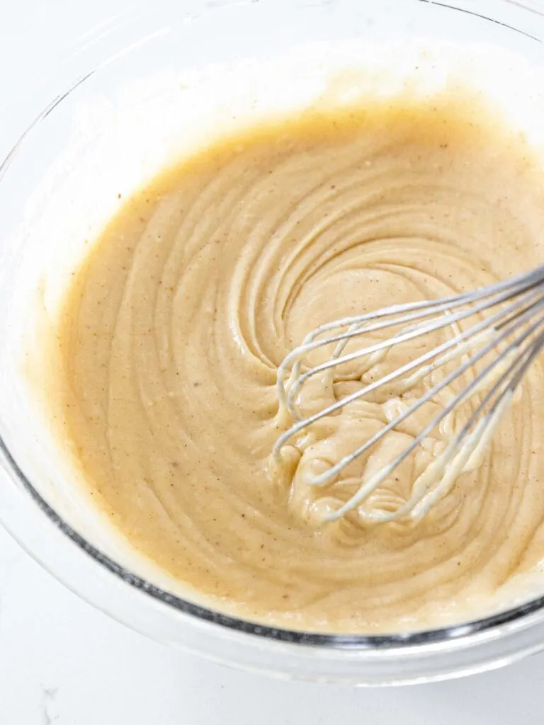 image of brown butter cupcake batter being mixed together with a whisk