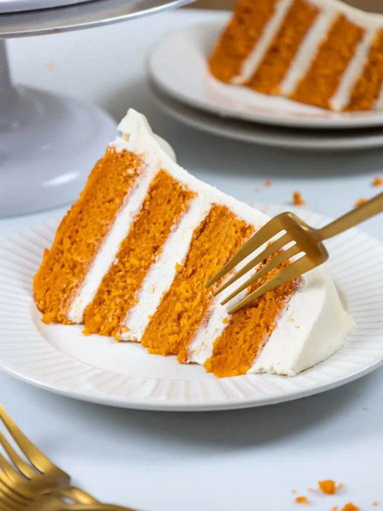 image of a fork about to cut into a slice of pumpkin layer cake