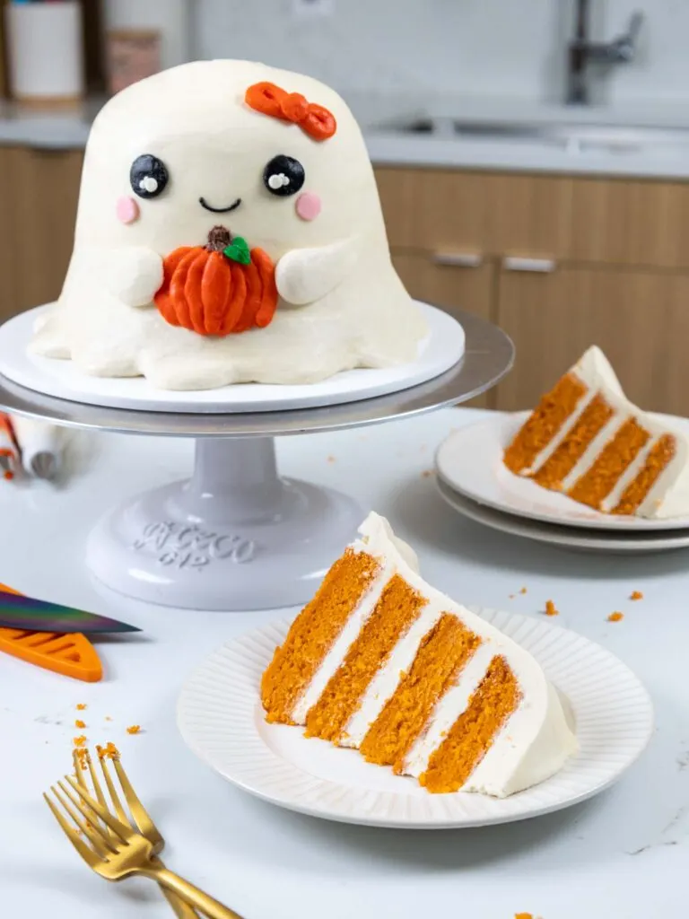 https://chelsweets.com/wp-content/uploads/2022/09/slices-of-pumpkin-cake-in-front-of-ghost-cake-768x1024.jpg.webp