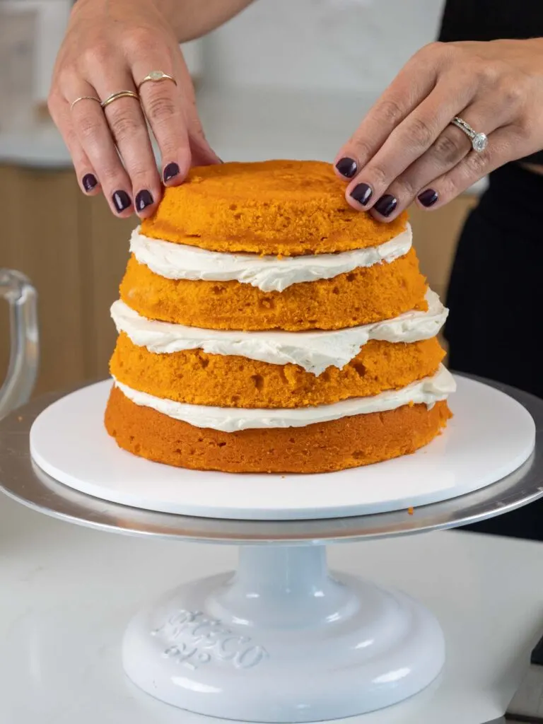 image of pumpkin cake layers that have been stacked with buttercream frosting