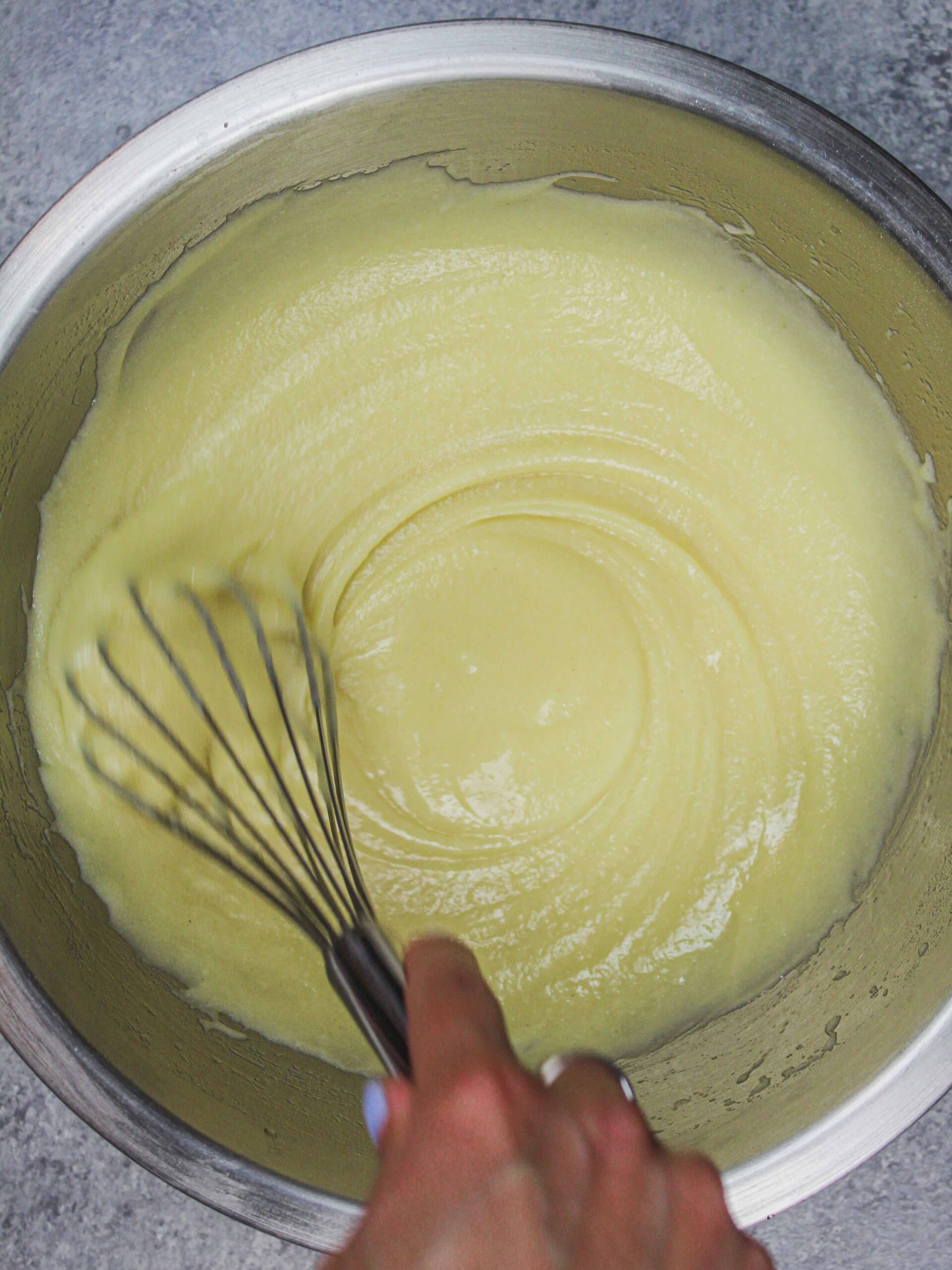 image of gluten free cake batter being overstirred to help give it the structure it needs