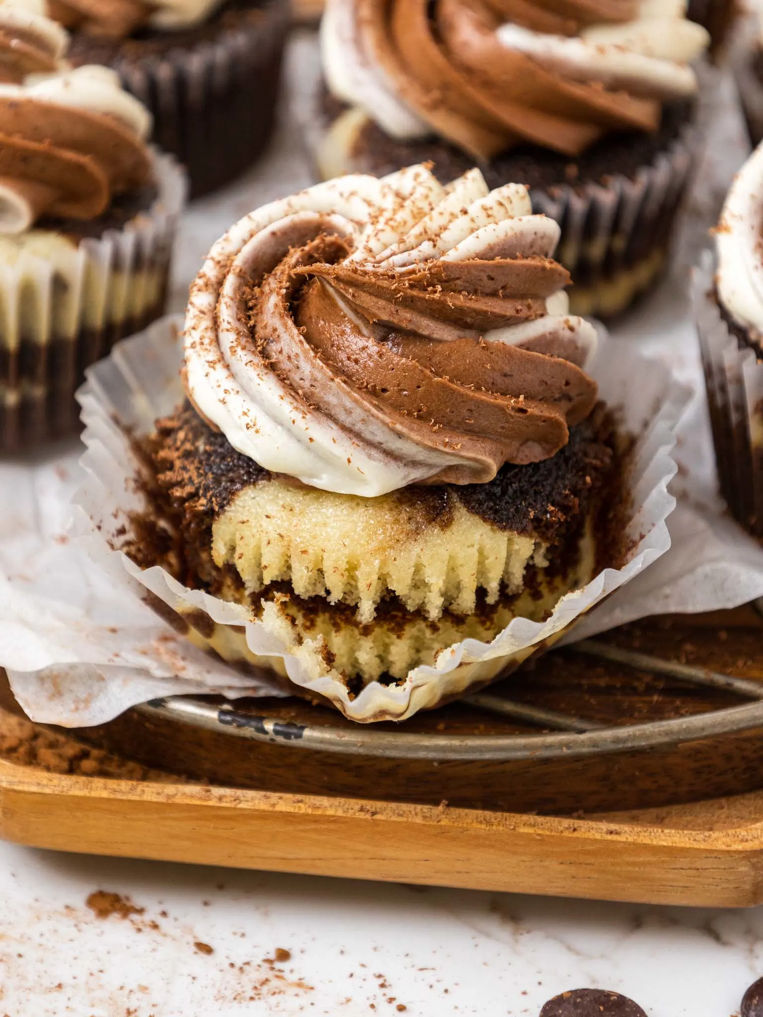 image of a moist marble cupcake that's been frosted with vanilla and chocolate buttercream and unwrapped