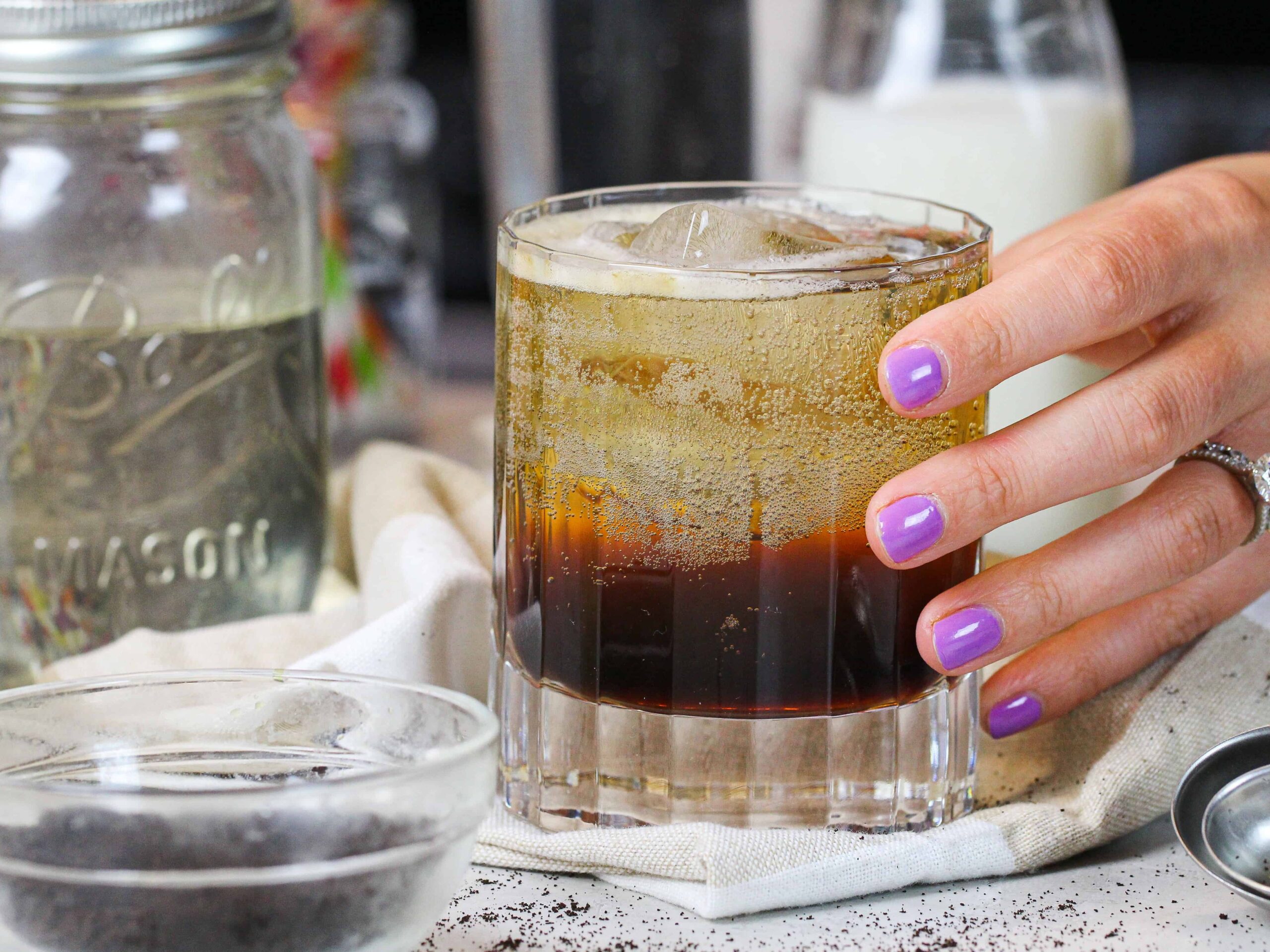 image of hand grabbing a freshly made espresso soda to enjoy as an afternoon pick-me-up
