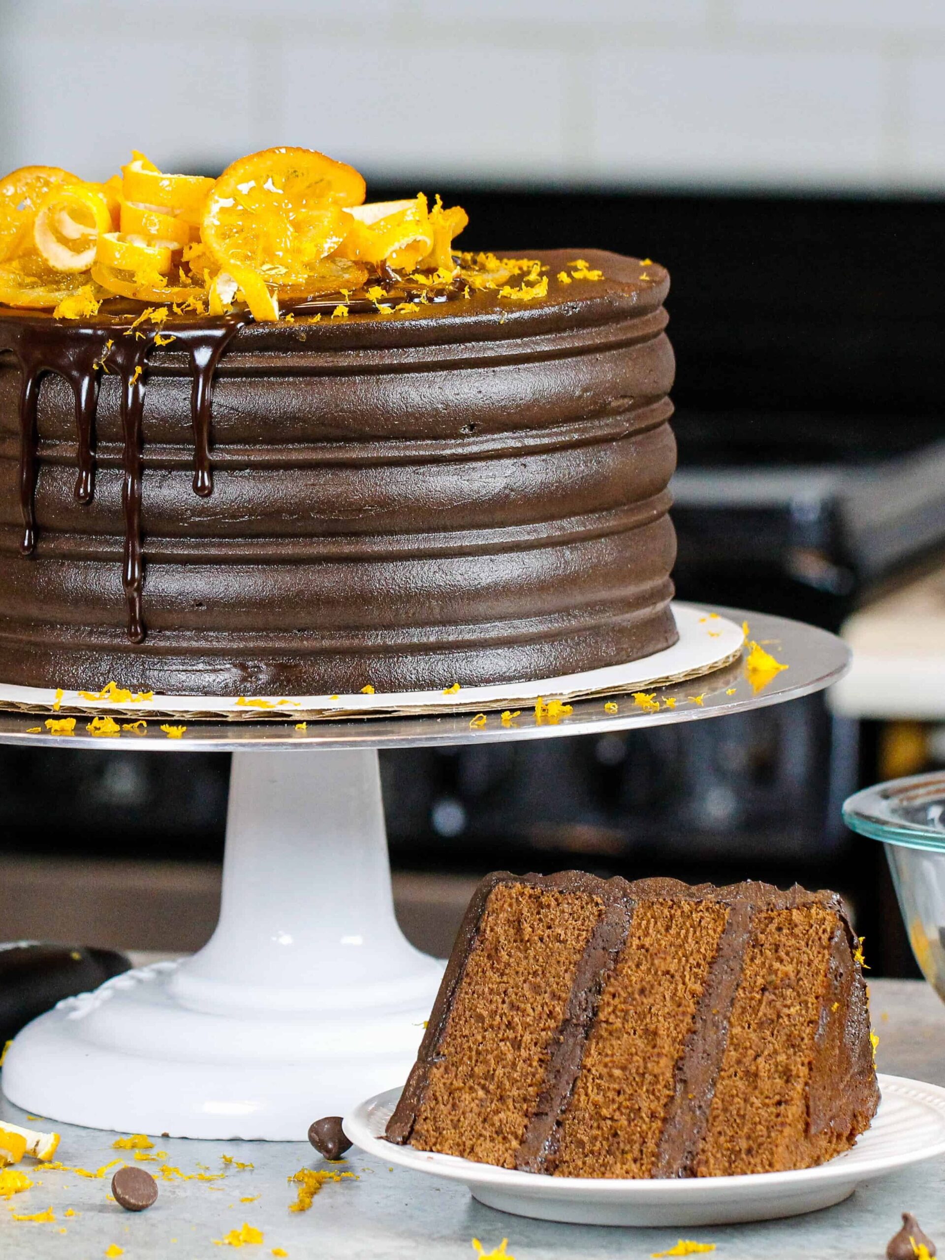image of chocolate orange cake with slice in front on a plate showing how fluffy and tender the cake layers are