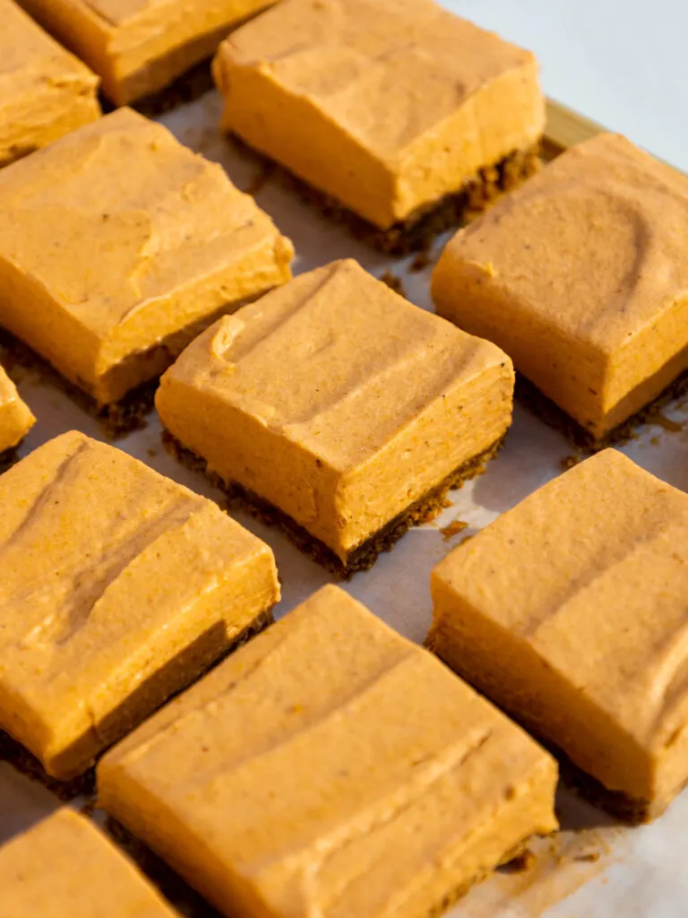 image of no bake pumpkin cheesecake bars that have been cut into squares