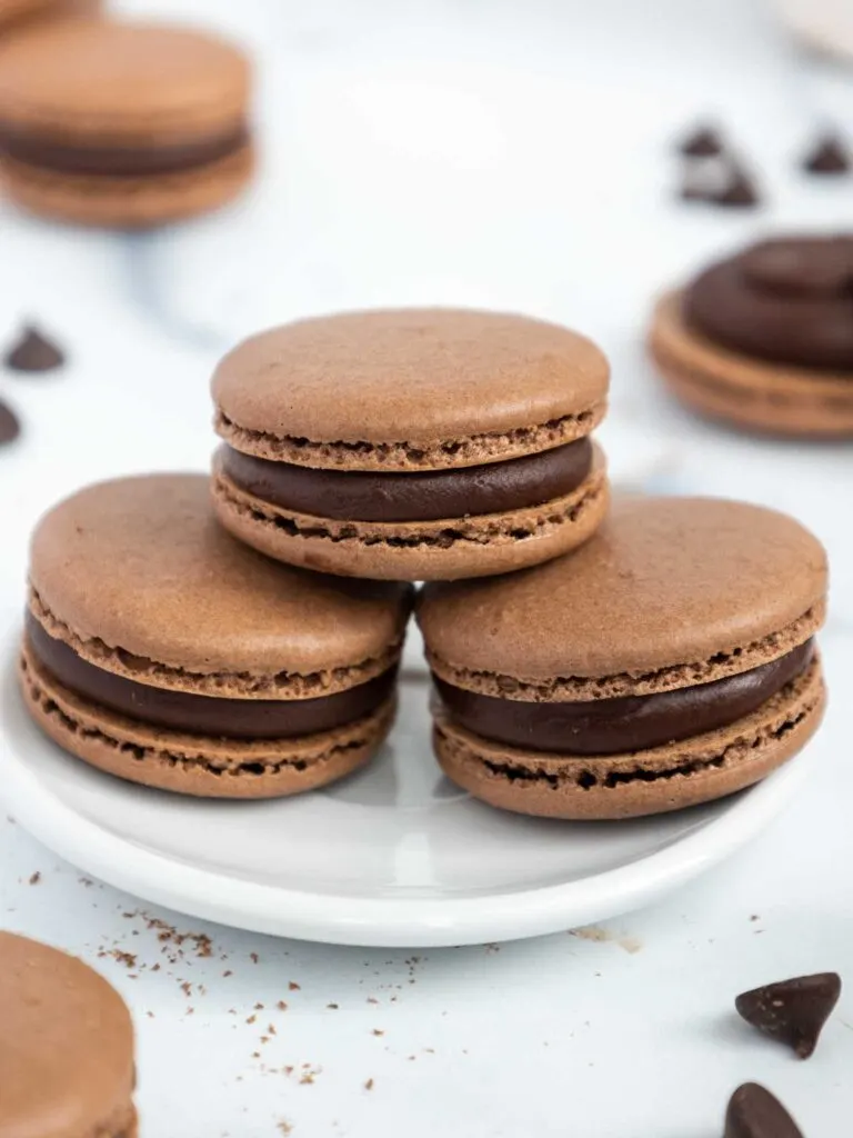 image of a stack of dark chocolate french macarons on a plate