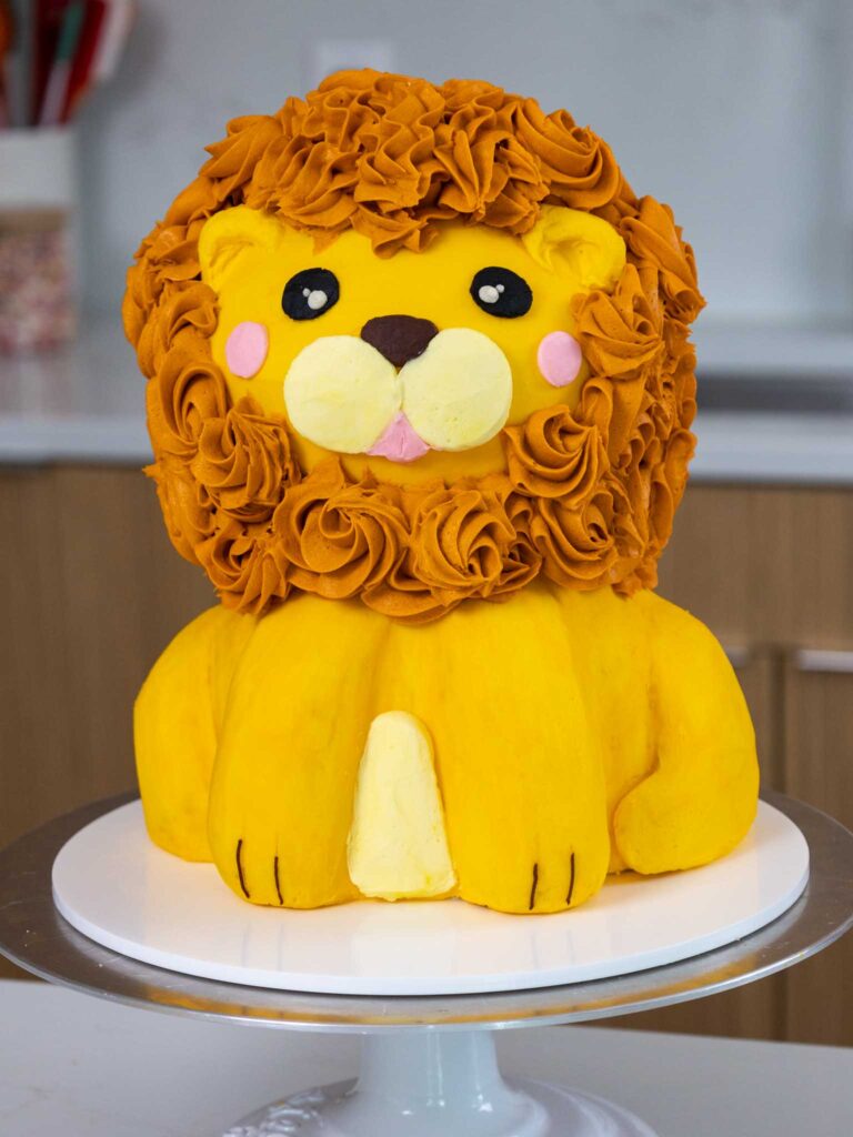 image of a cute lion birthday cake decorated with vanilla buttercream