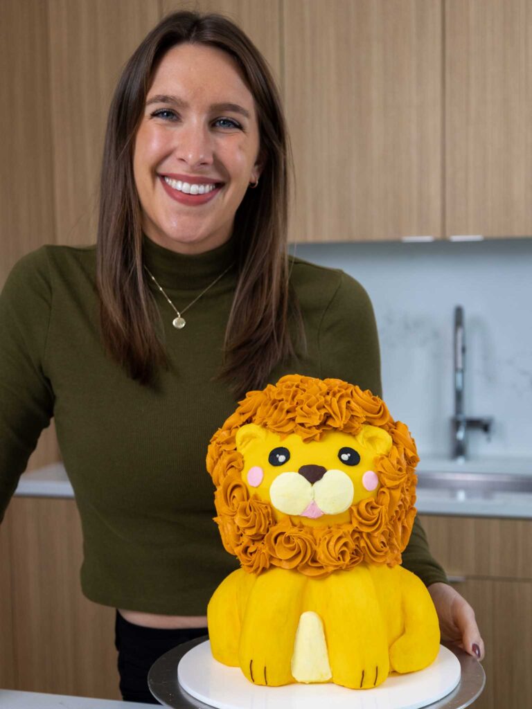 image of chelsey white of chelsweets with a cute lion cake she made for her animal cake series