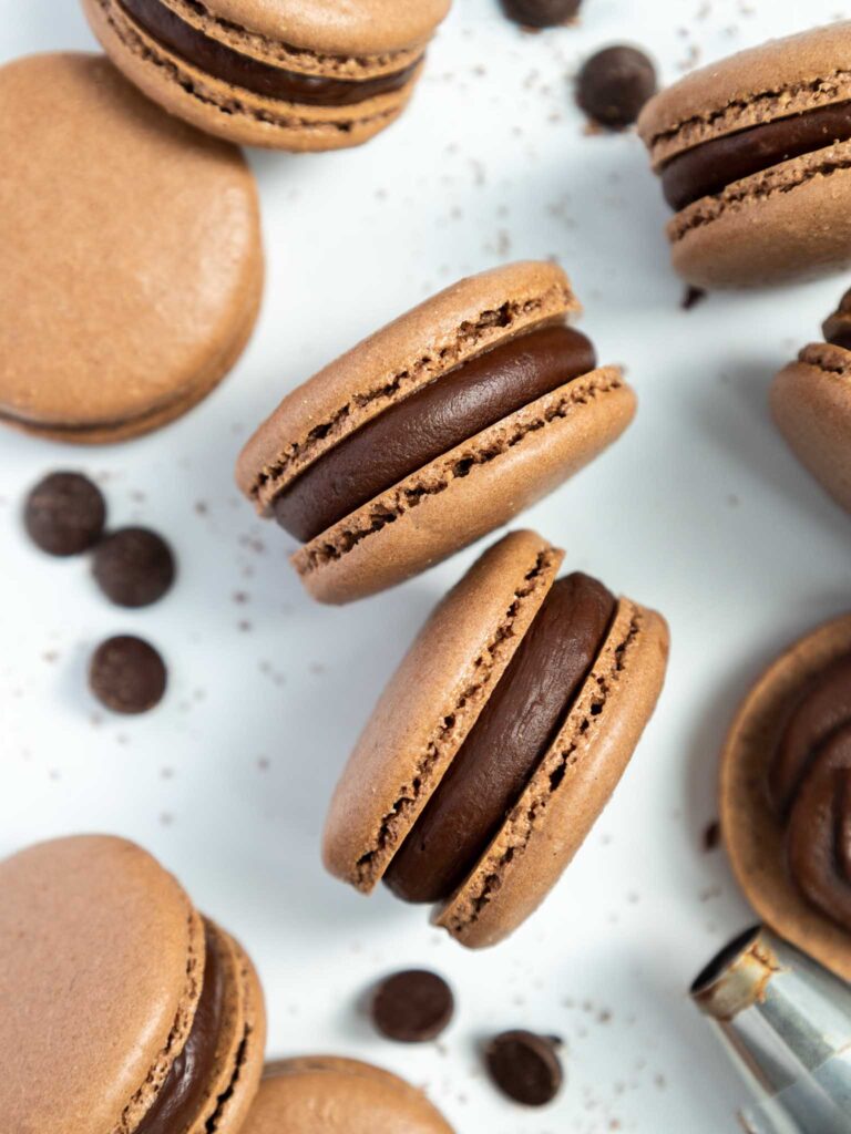 image of dark chocolate macarons that have been filled with dark chocolate ganache