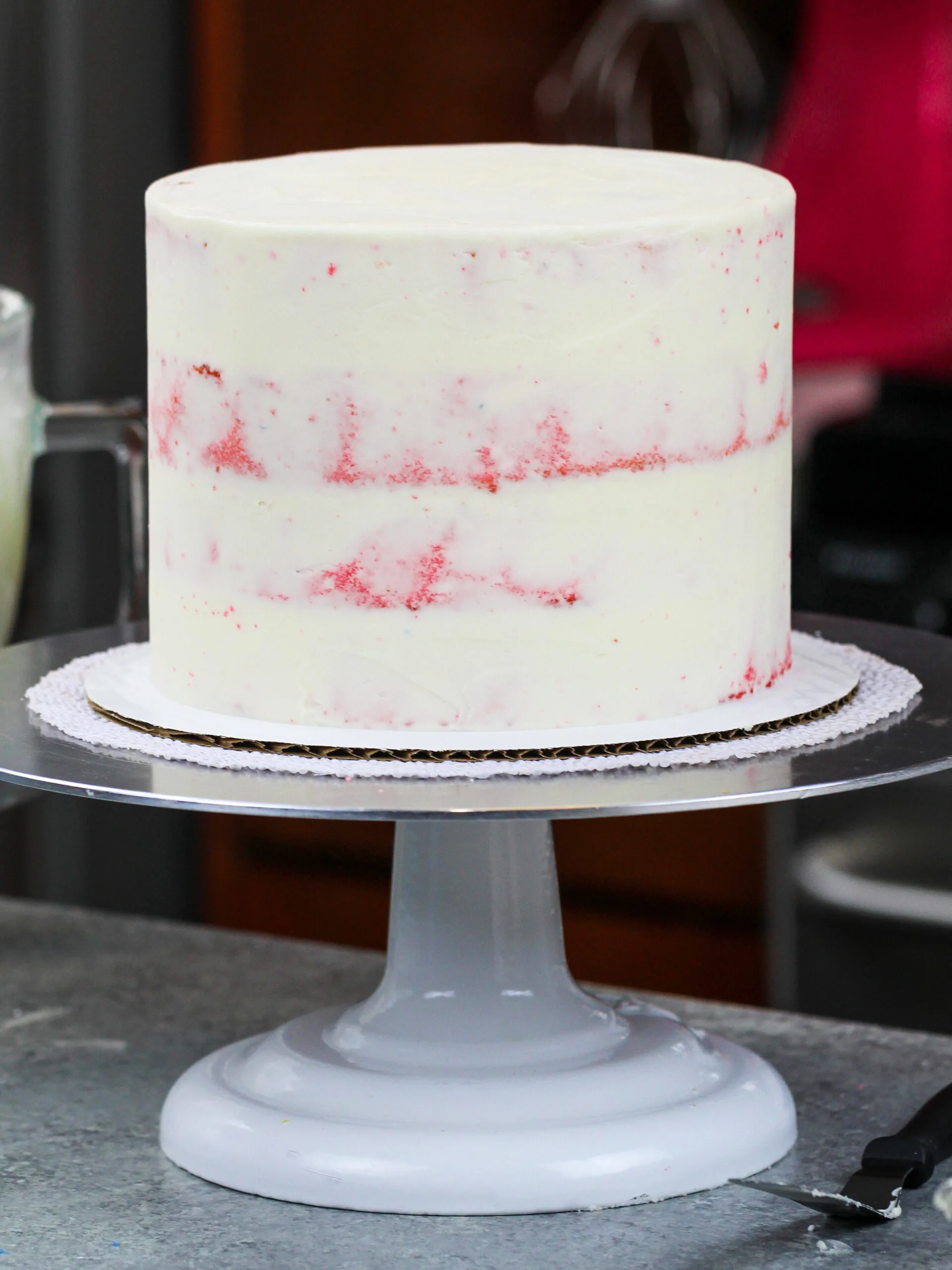 image of pink cake layers that have been crumb coated