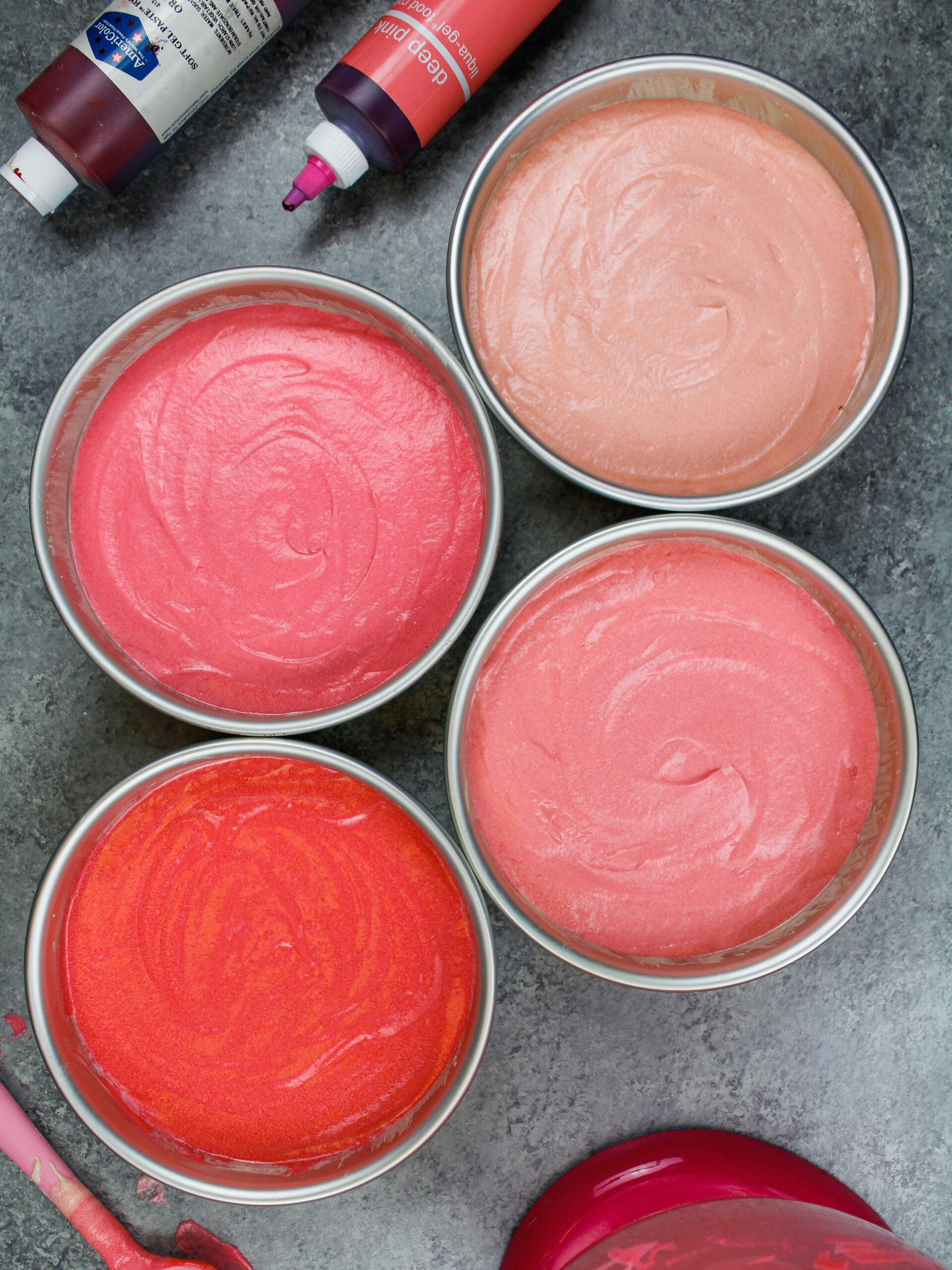image of pink ombre cake batter that's been poured into pans and is ready to be baked