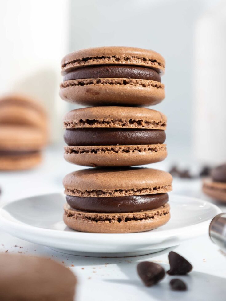image of a stack of dark chocolate french macarons on a plate