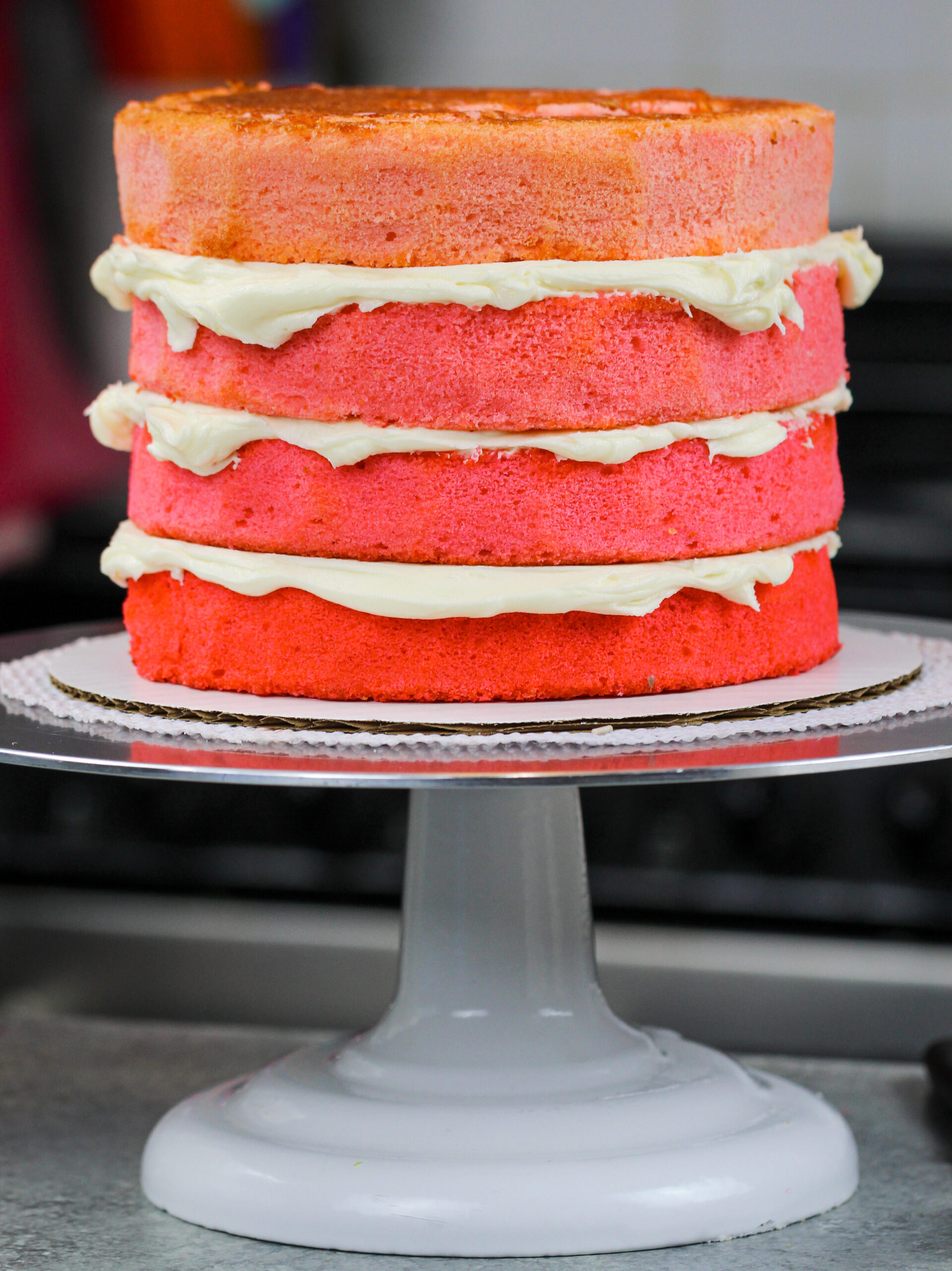 image of pink ombre cake layers that have been stacked and are ready to be frosted