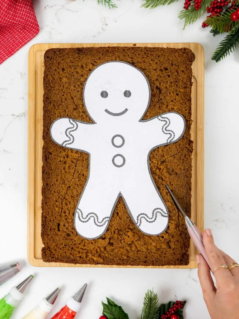 image of a sheet cake being cut into the shape of a gingerbread man