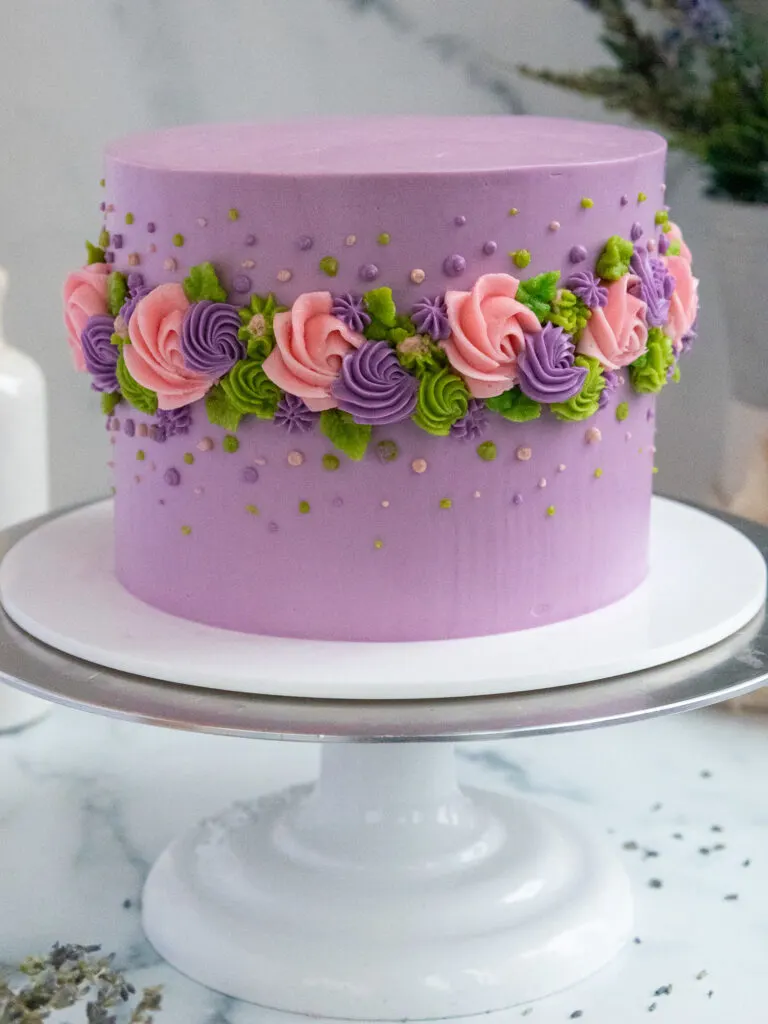 image of an earl grey lavender layer cake decorated with buttercream flowers