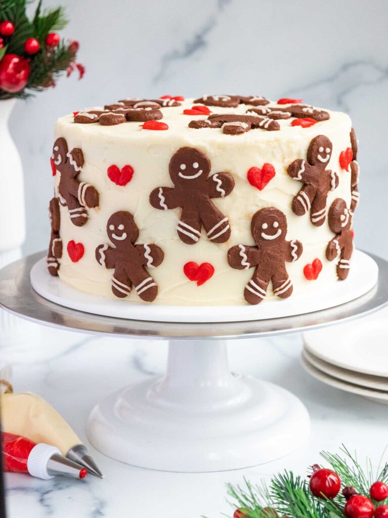 image of a gingerbread layer cake decorated with buttercream gingerbread men