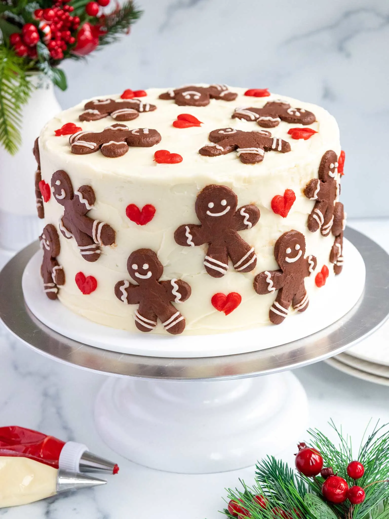 image of a gingerbread layer cake decorated with buttercream gingerbread men